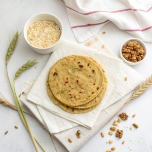 Light brown oats roti, soft and pliable, served with mixed vegetable sabzi